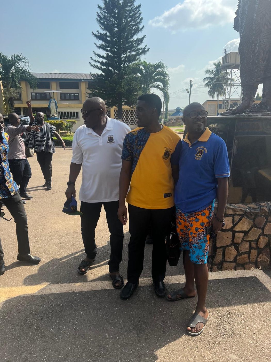 Akatakyie members in school colours outside the assembly hall after a general meeting