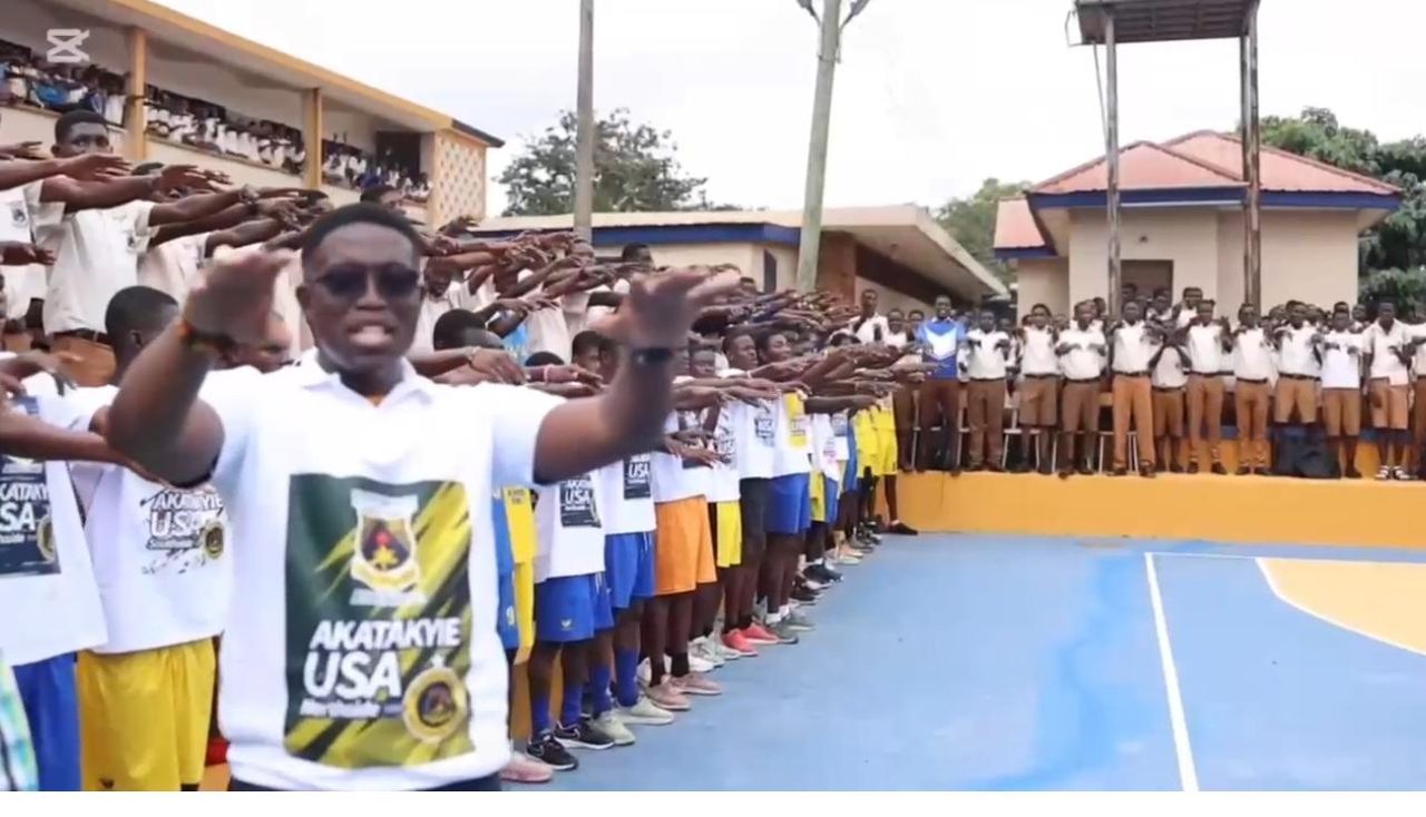 Students lined up along a newly built multipurpose court at Opoku Ware School