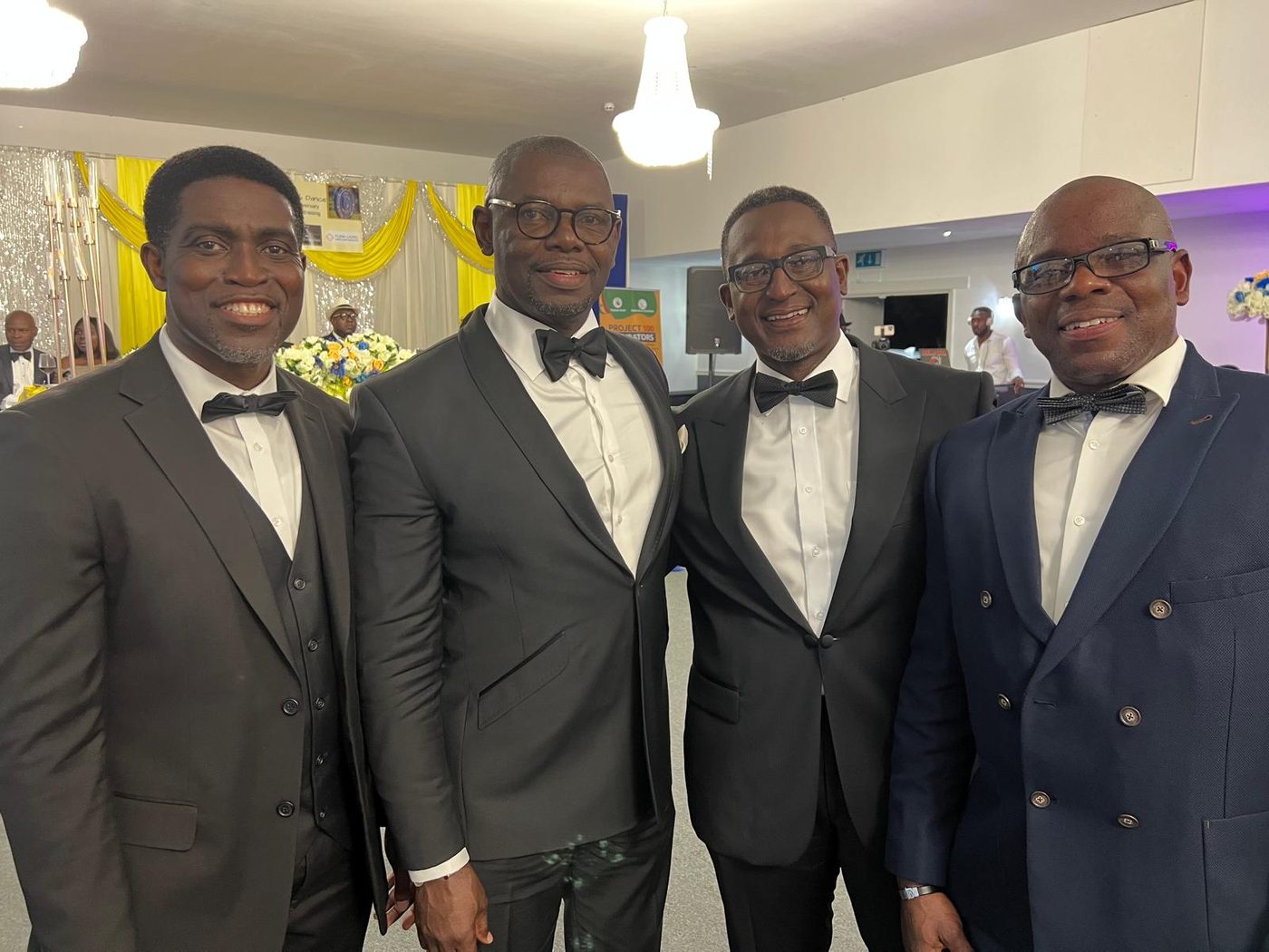 Four Akatakyie members in black tie at a formal association dinner