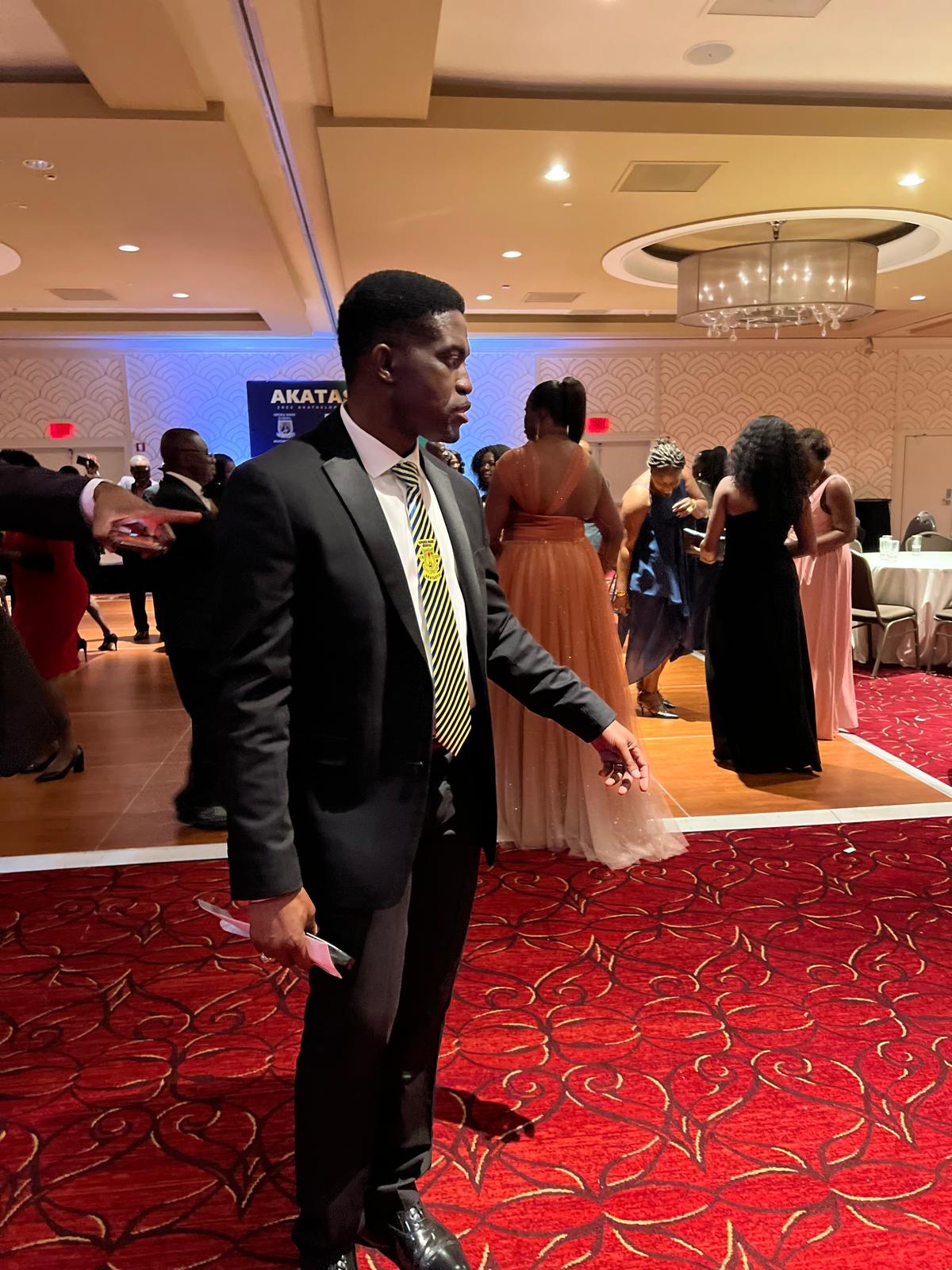 An Akatakyie member in a suit and school tie on the dance floor at the New Jersey endowment fundraiser dinner